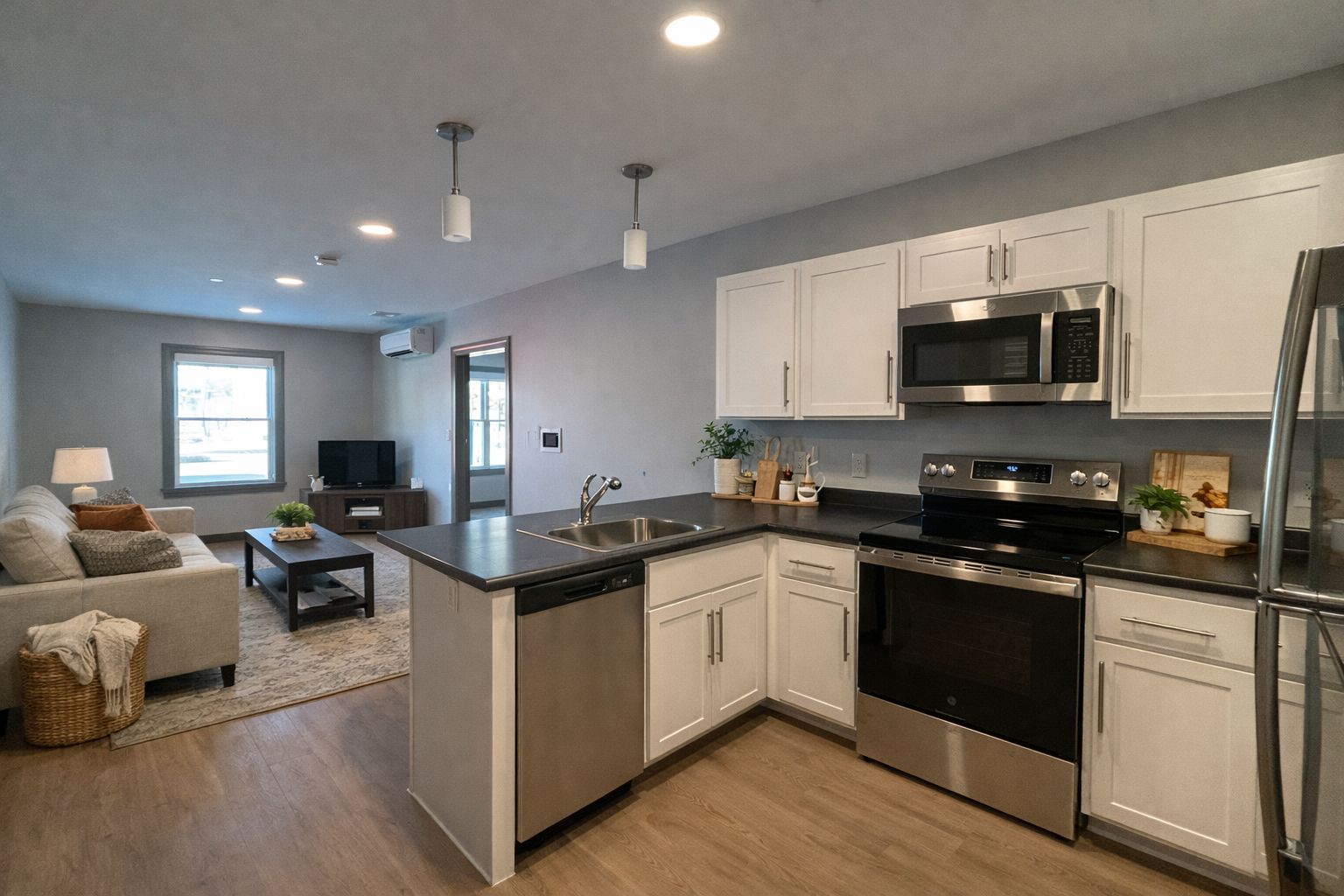 A staged kitchen and living room area in a 2 bedroom apartment.