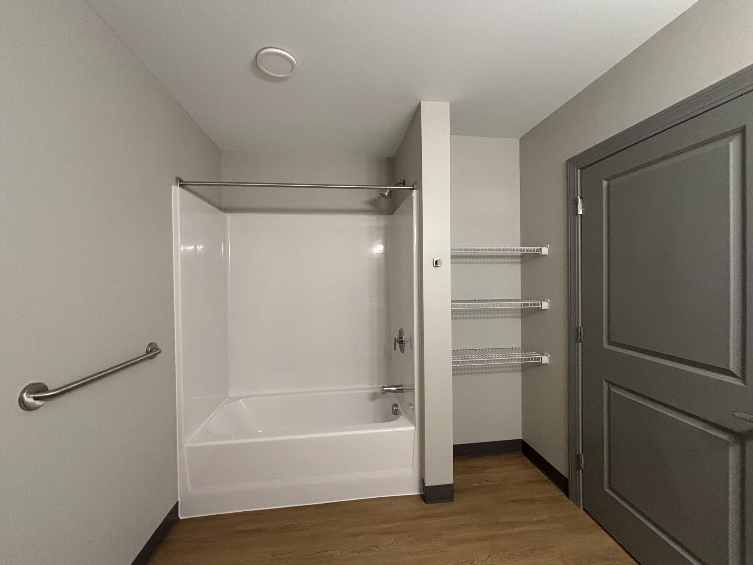View of the shower and linen closet of the bathroom of a 2 bedroom affordable living apartment.
