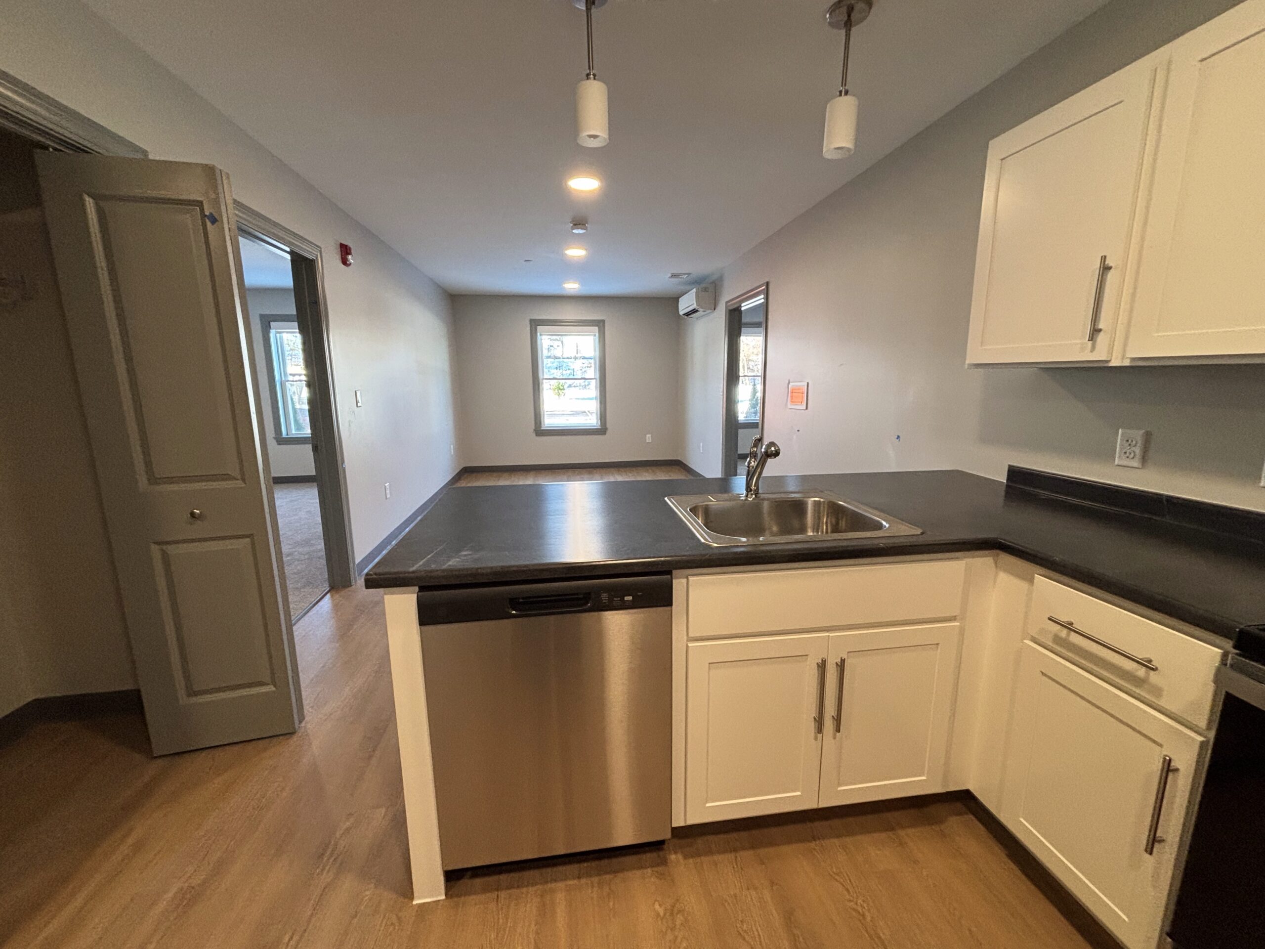 A view of the living space from the kitchen in a 2 bedroom affordable living apartment.