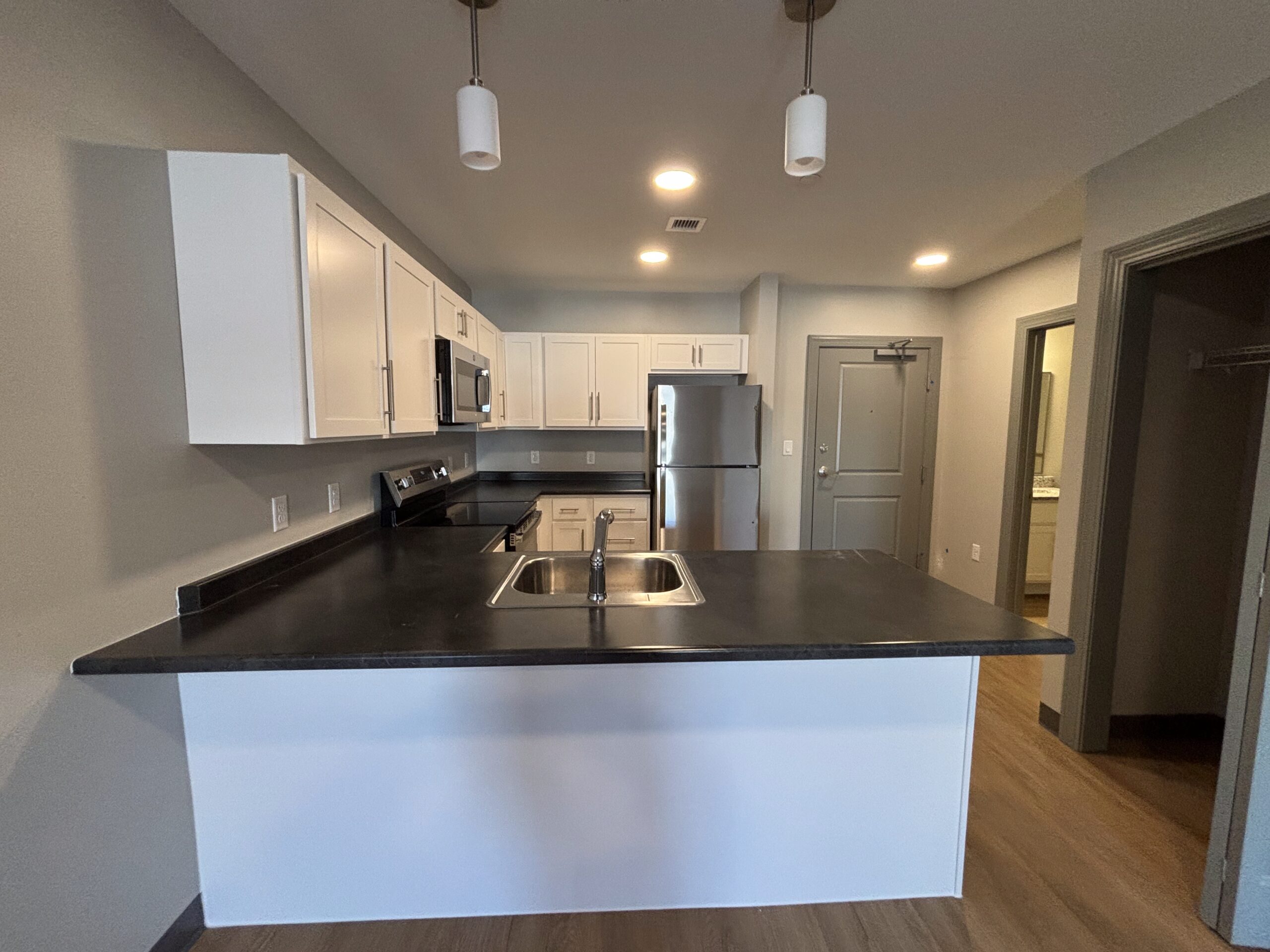 View into the kitchen from the living space of a 2 bedroom affordable living apartment.