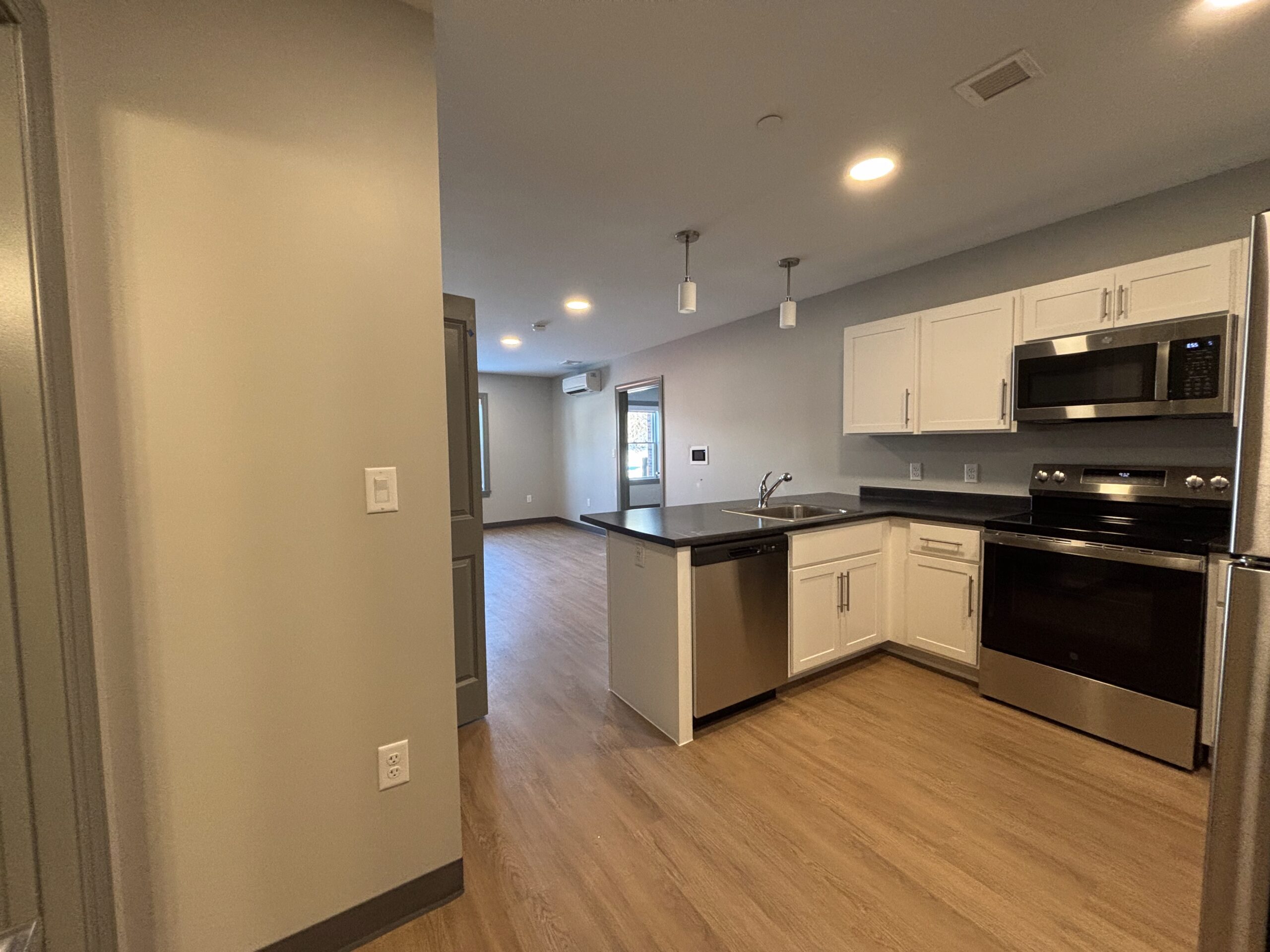 The entrance into a kitchen of a 2 bedroom affordable living apartment.